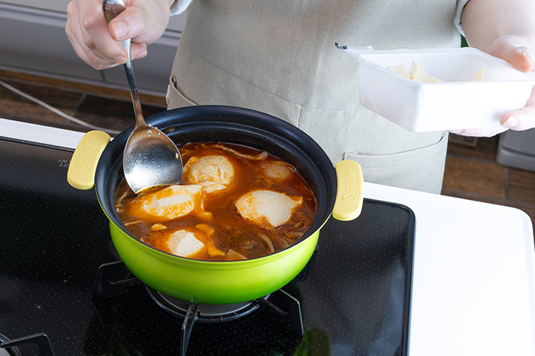 あさりの殻が開いたら弱火にし、絹豆腐をお好みの大きさにすくい入れる