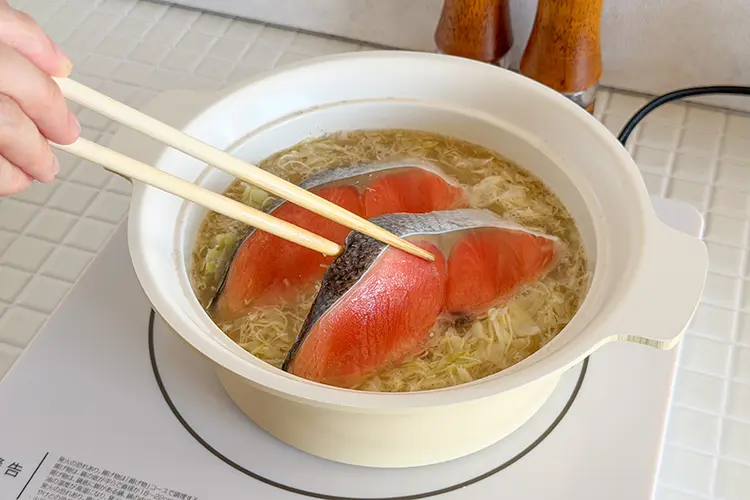 ひと煮立ちしたら、キャベツ、塩鮭の順に加え蓋をし、5分程度加熱する。